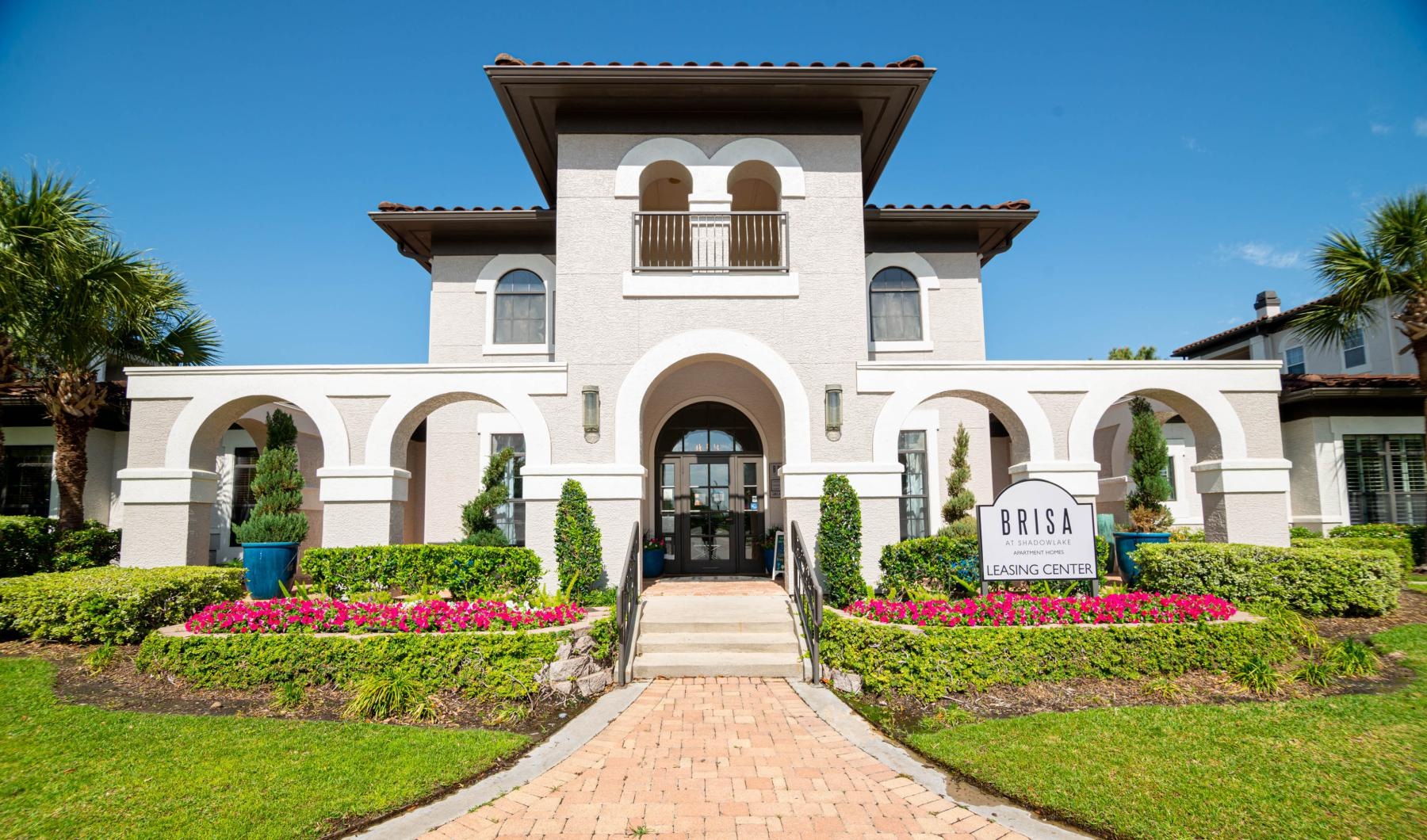 a white house with a brick walkway